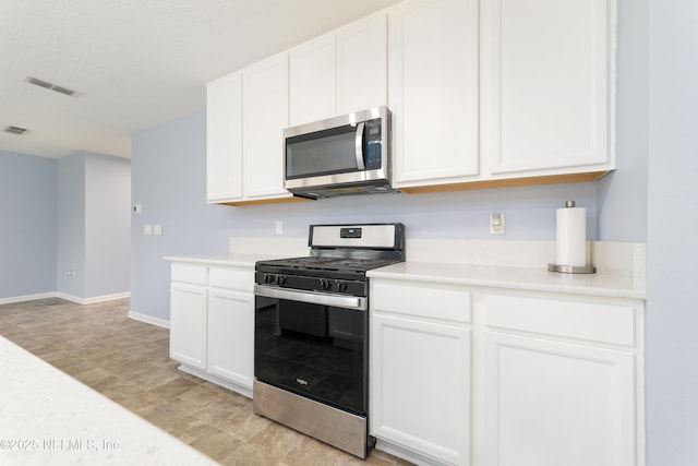 kitchen with appliances with stainless steel finishes and white cabinetry