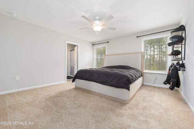 carpeted bedroom featuring ceiling fan and connected bathroom