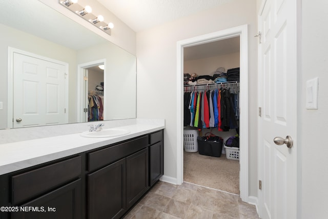 bathroom with a textured ceiling and vanity