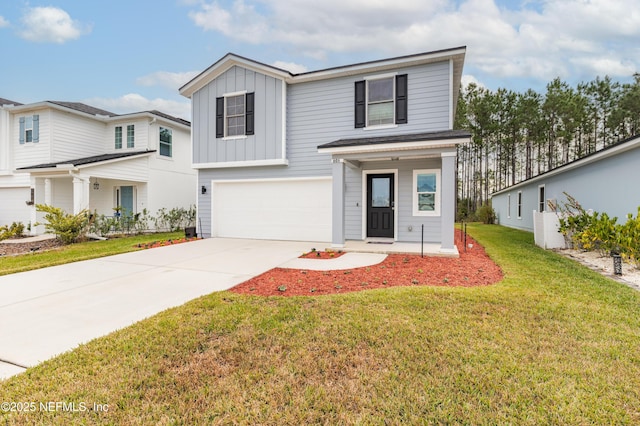 view of front of house featuring a front lawn and a garage