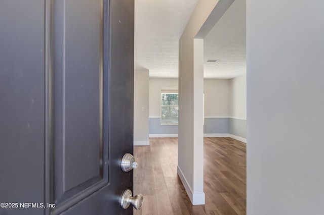 corridor featuring hardwood / wood-style floors