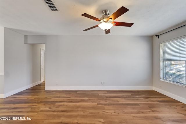 spare room featuring hardwood / wood-style flooring and ceiling fan