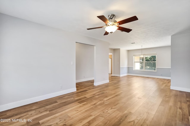 unfurnished living room featuring ceiling fan and light wood-type flooring