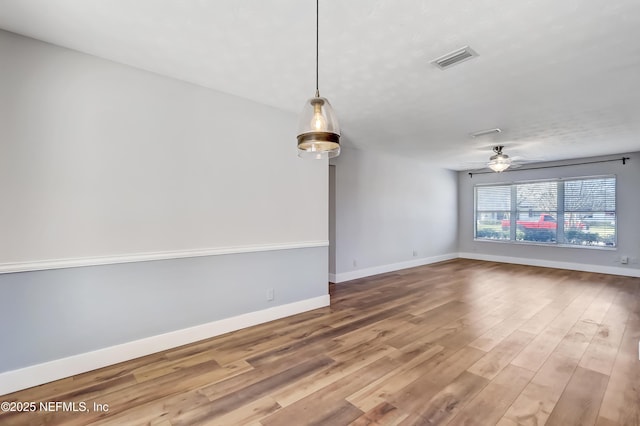 unfurnished living room with ceiling fan and wood-type flooring