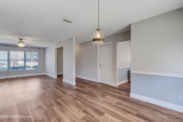 empty room featuring ceiling fan and hardwood / wood-style floors