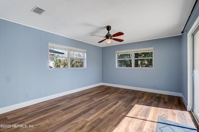 unfurnished room featuring dark wood-type flooring and ceiling fan