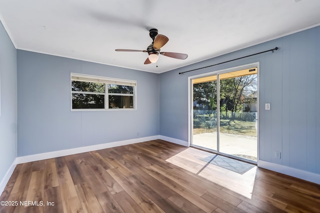 spare room featuring dark wood-type flooring and ceiling fan