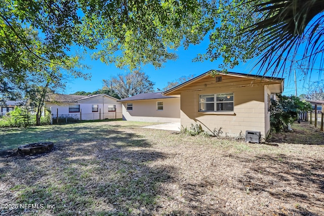 rear view of house featuring a patio area and a lawn