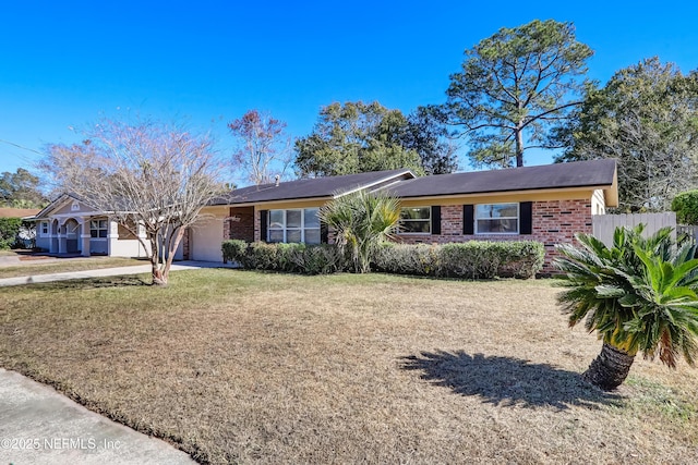 ranch-style home featuring a garage and a front yard