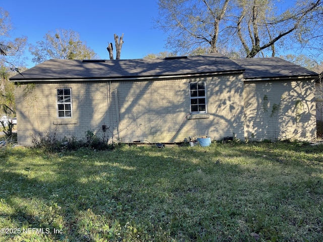 view of side of home featuring a yard