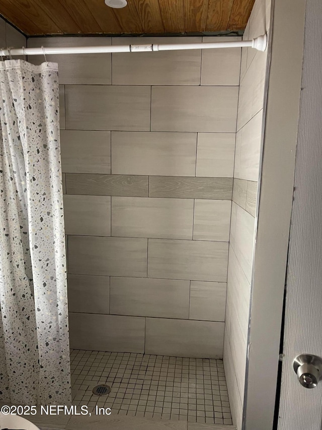 bathroom with wooden ceiling and a shower with curtain