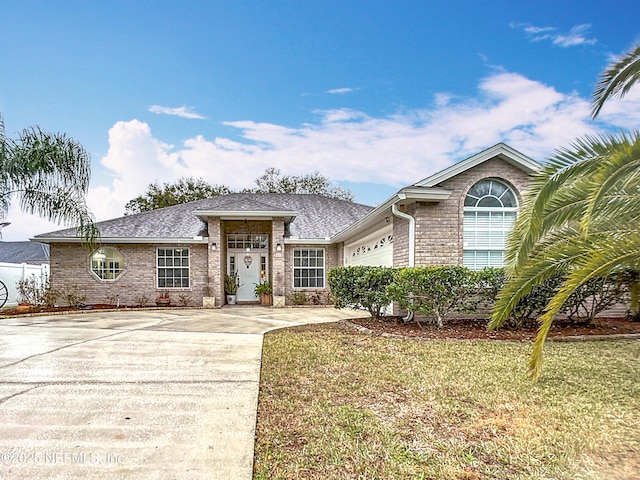 view of front of property featuring a garage and a front lawn