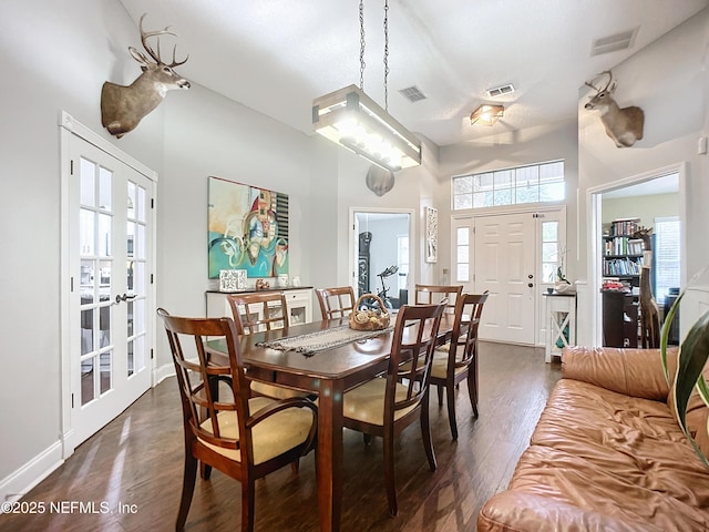 dining room with dark hardwood / wood-style floors and french doors