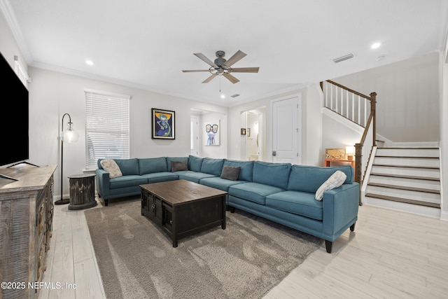 living room with light hardwood / wood-style flooring, ceiling fan, and ornamental molding