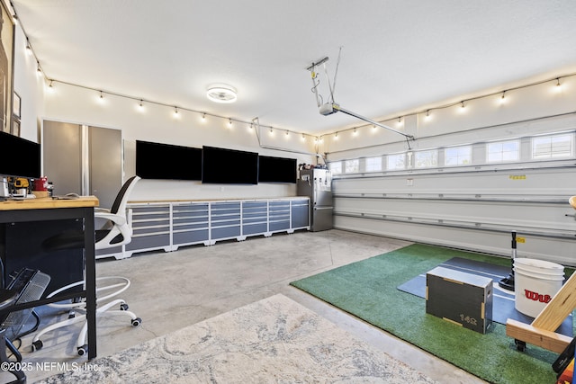 garage with stainless steel fridge and a garage door opener