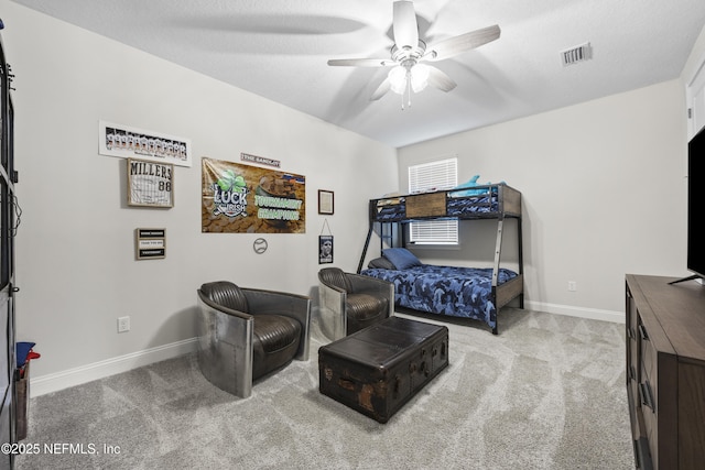 bedroom with light carpet, a textured ceiling, and ceiling fan