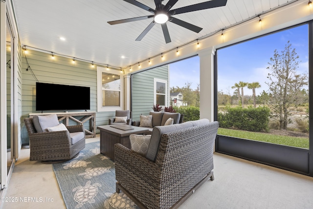 sunroom featuring ceiling fan and track lighting