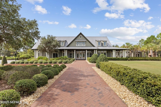 view of front of home featuring a front yard and french doors