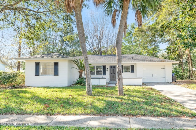 single story home featuring a front lawn and a garage