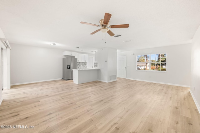 unfurnished living room featuring ceiling fan and light hardwood / wood-style flooring