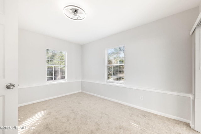 unfurnished room with light carpet