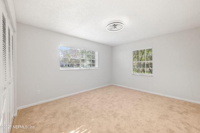 unfurnished room with light carpet