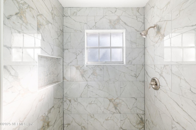 bathroom featuring tiled shower