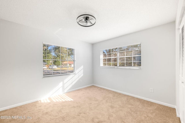 unfurnished room featuring light carpet