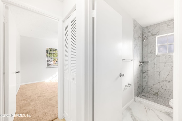 bathroom with tiled shower