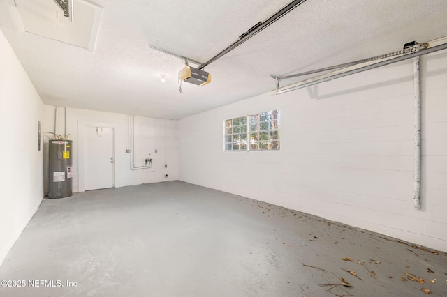 garage with a garage door opener and electric water heater