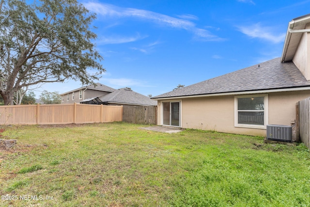 view of yard with central AC unit and a fenced backyard