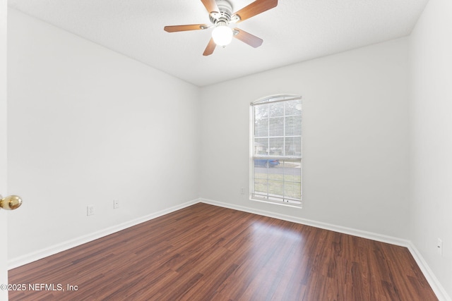 unfurnished room with a ceiling fan, baseboards, and wood finished floors