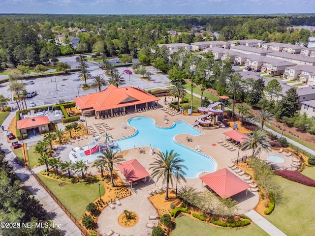 birds eye view of property with a wooded view and a residential view