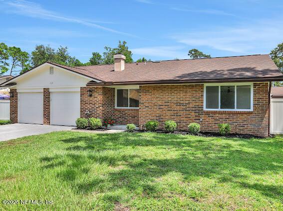 ranch-style house featuring a front lawn and a garage