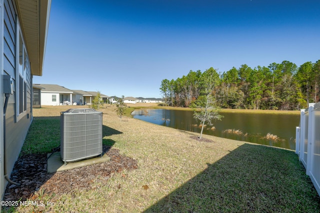 view of yard featuring central AC unit and a water view