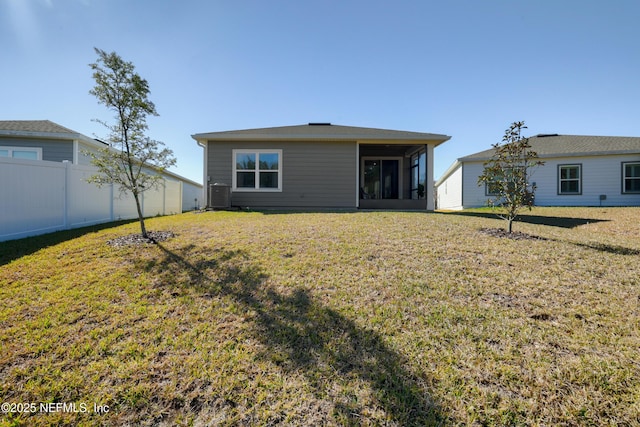 back of property featuring a yard and a sunroom