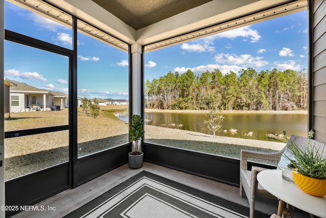 sunroom / solarium with a water view