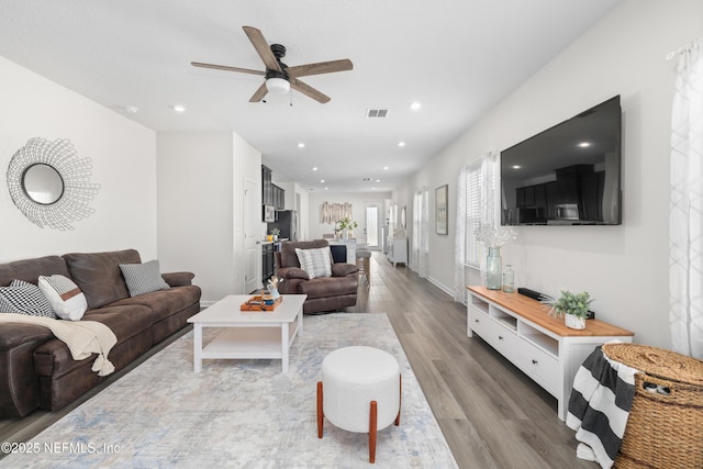 living room with ceiling fan and hardwood / wood-style floors