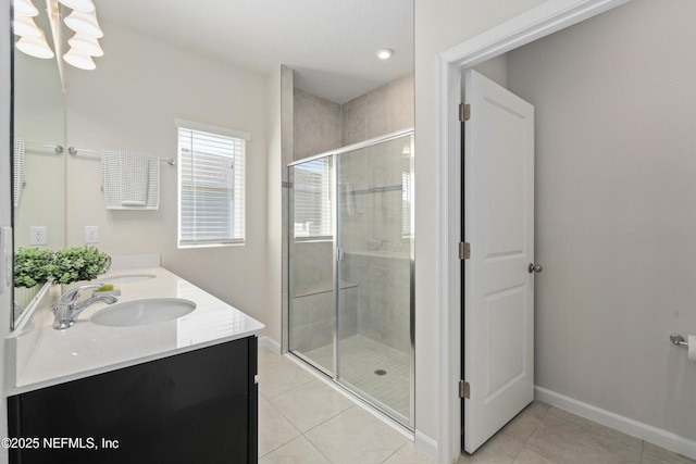 bathroom featuring tile patterned flooring, a shower with shower door, and vanity