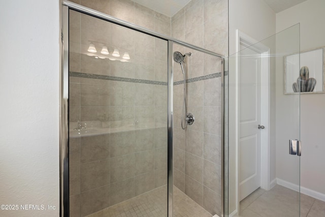 bathroom featuring walk in shower and tile patterned flooring