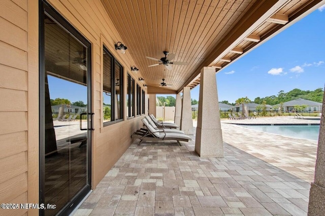 view of patio / terrace with ceiling fan and a community pool