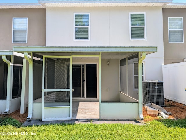 back of house featuring a sunroom and central AC unit