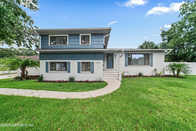 split level home featuring a front lawn