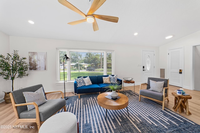 living room featuring ceiling fan and wood-type flooring