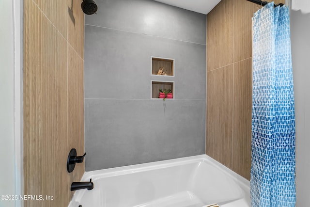 bathroom with shower / bathtub combination with curtain