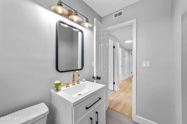 bathroom with toilet and vanity