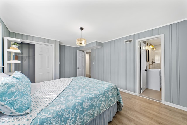 bedroom with sink, ensuite bathroom, a closet, and light wood-type flooring