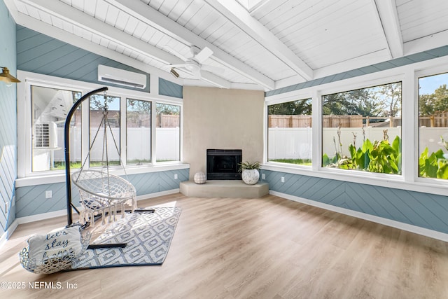 sunroom featuring vaulted ceiling with beams, ceiling fan, a wealth of natural light, and a wall mounted AC