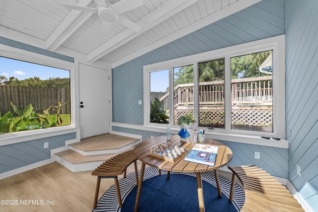 sunroom / solarium featuring ceiling fan and vaulted ceiling with beams