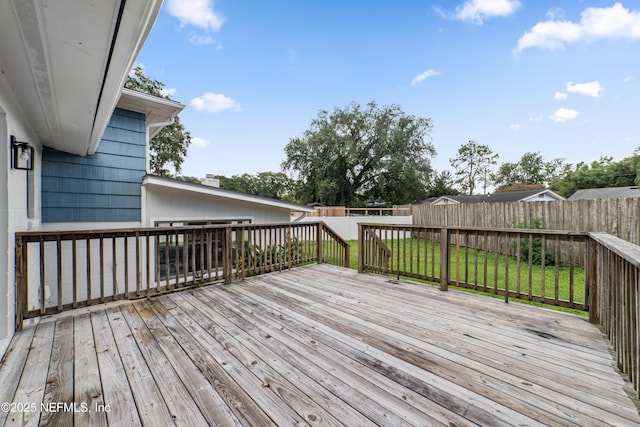 wooden deck with a lawn